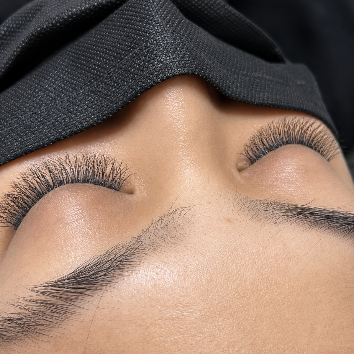 Close-up of full, curled eyelash extensions applied at Mariana Nails in Saipan