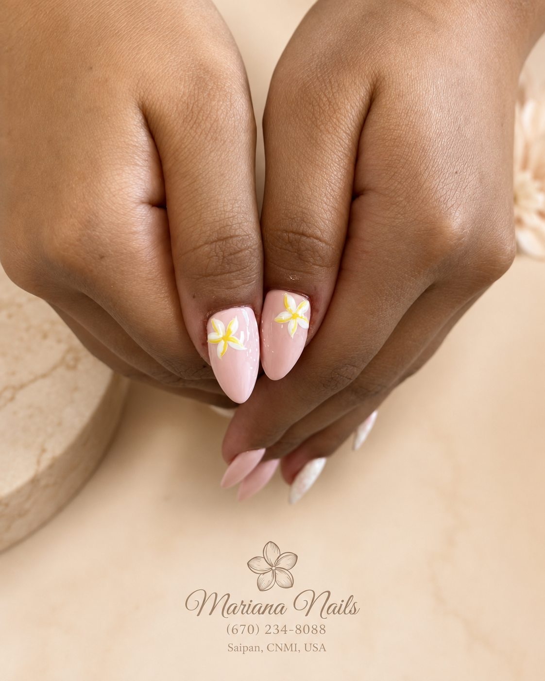 Soft pink almond nails with hand-painted yellow and white plumeria flower accents by Mariana Nails in Saipan
