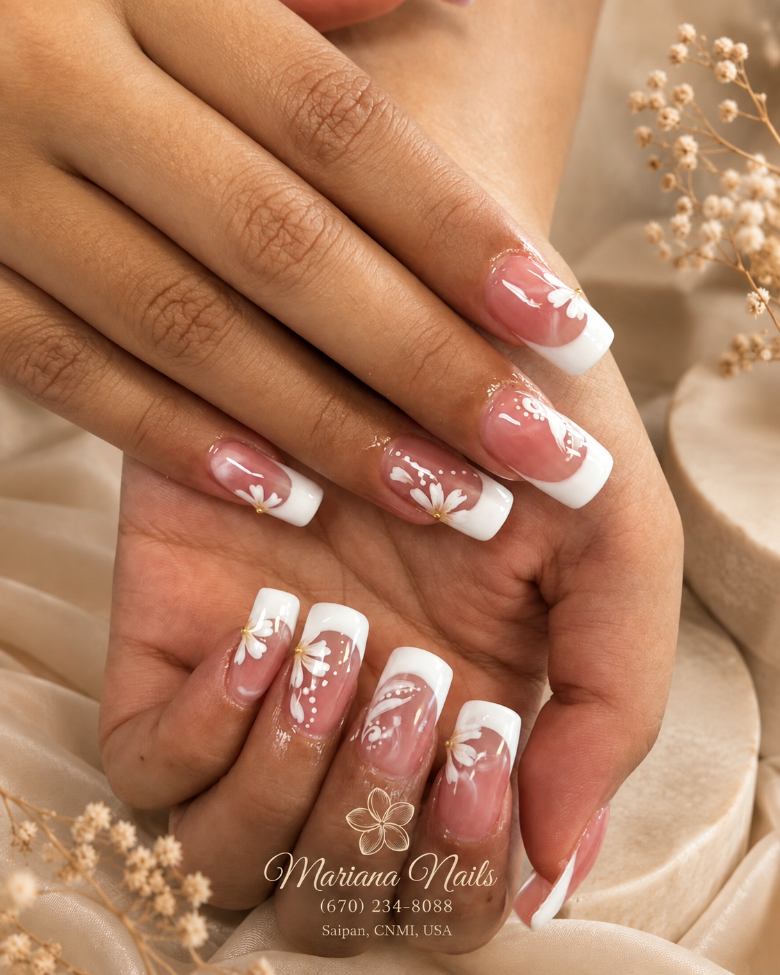 Glossy nude pink square acrylic nails with white French tips and delicate white floral nail art by Mariana Nails in Saipan